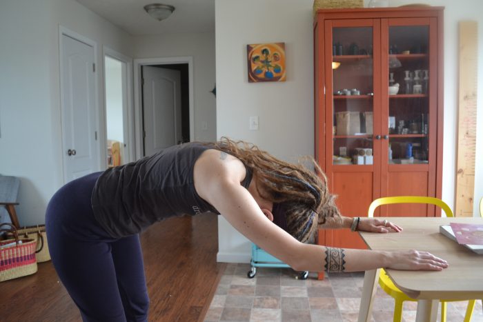 Back and shoulder stretch for postpartum wellness.