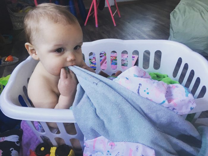 baby in laundry basket